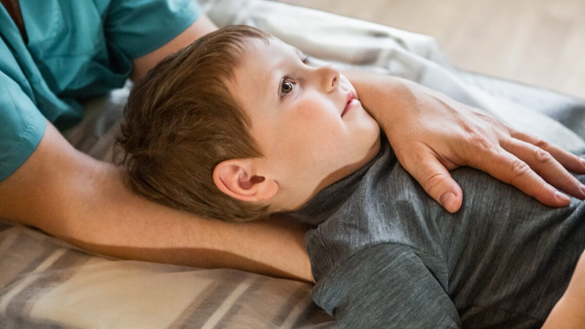 Gentle touch, child resting peacefully.